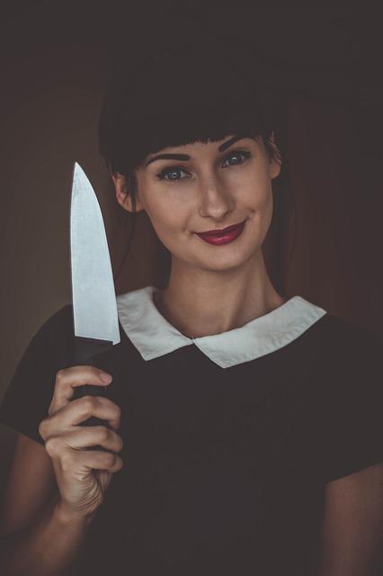 woman smiling and holding large knife